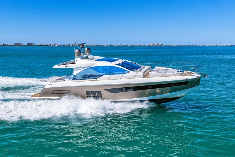 Slide: The Image of Luxury 2020 Azimut S6 yacht cruising on clear blue ocean waters. - 65