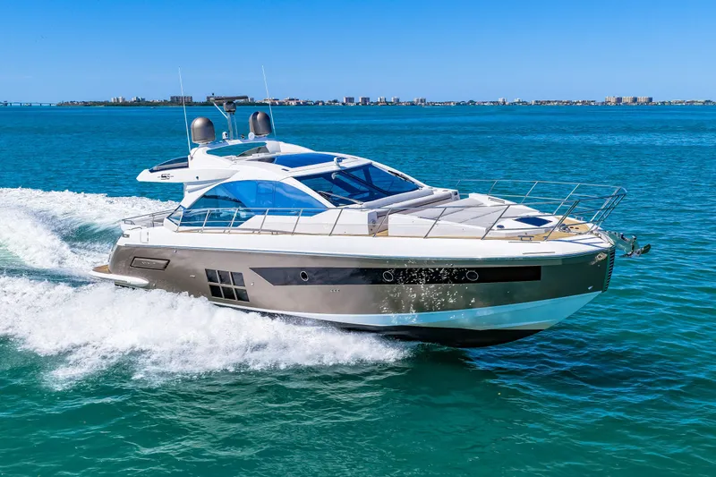 Slide: The Image of Luxury 2020 Azimut S6 yacht cruising on clear blue ocean waters. - 66
