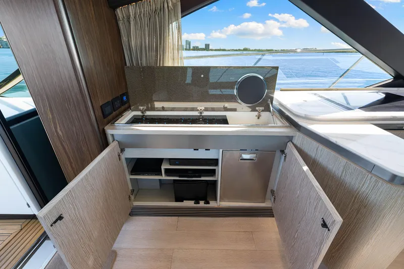Slide: The Image of Modern kitchen area on a 2020 Azimut S6 yacht with open cabinets and ocean view. - 94