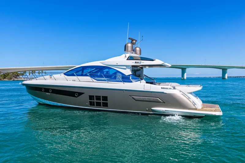 Slide: The Image of 2020 Azimut S6 yacht cruising on clear blue water near a bridge. - 17