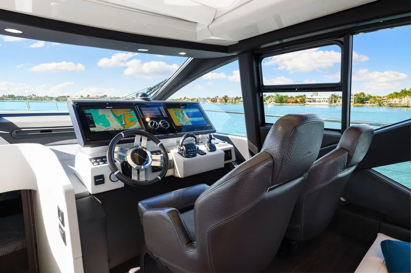 Slide: The Image of Interior view of 2020 Azimut S6 yacht cockpit with navigation screens and leather seats. - 98