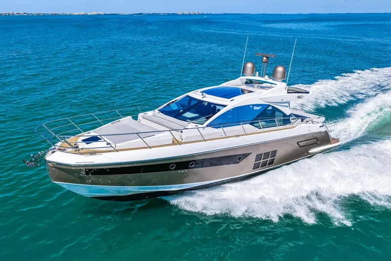 Slide: The Image of Luxurious 2020 Azimut S6 yacht cruising on clear blue ocean waters. - 76