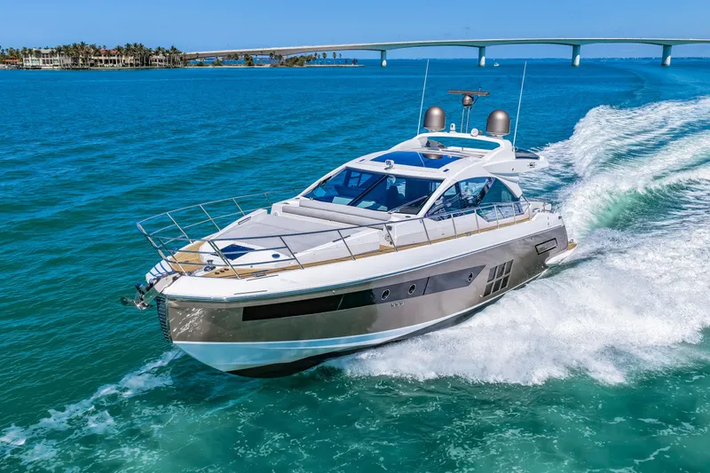 Slide: The Image of Luxury 2020 Azimut S6 yacht cruising on turquoise waters near a bridge. - 42