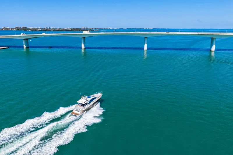 Slide: The Image of Azimut S6 yacht cruising under a bridge on clear blue waters, 2020 model. - 51