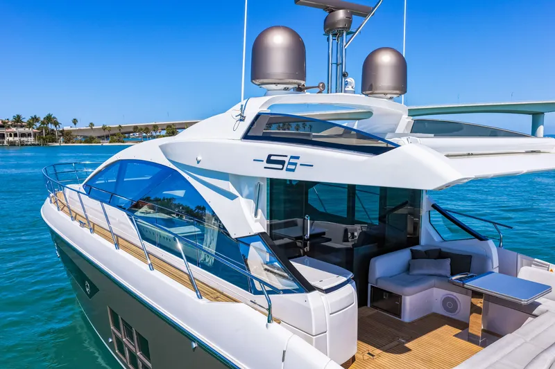 Slide: The Image of 2020 Azimut S6 yacht on clear blue water, showcasing sleek design and luxurious deck. - 20
