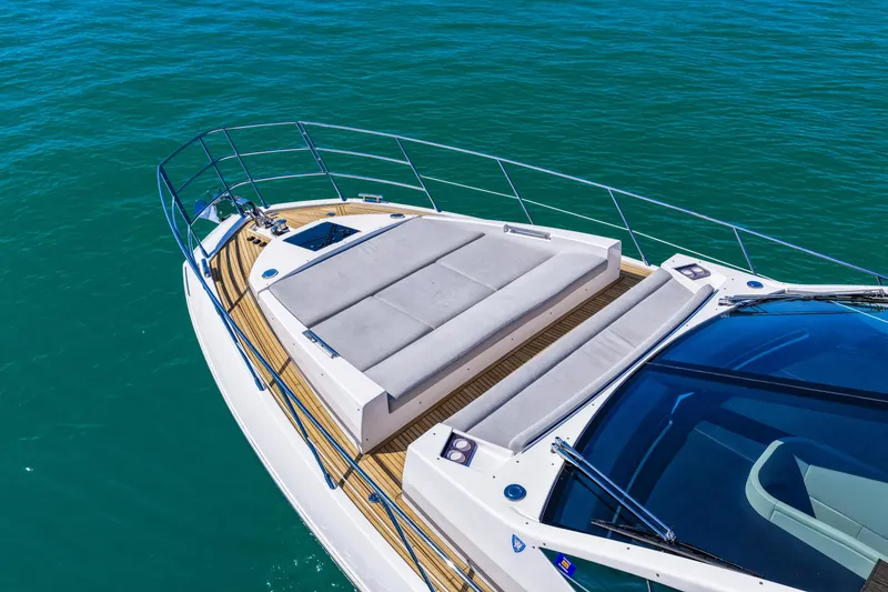 Slide: The Image of Luxury Azimut S6 yacht deck with sunbeds, 2020 model, on clear blue water. - 14
