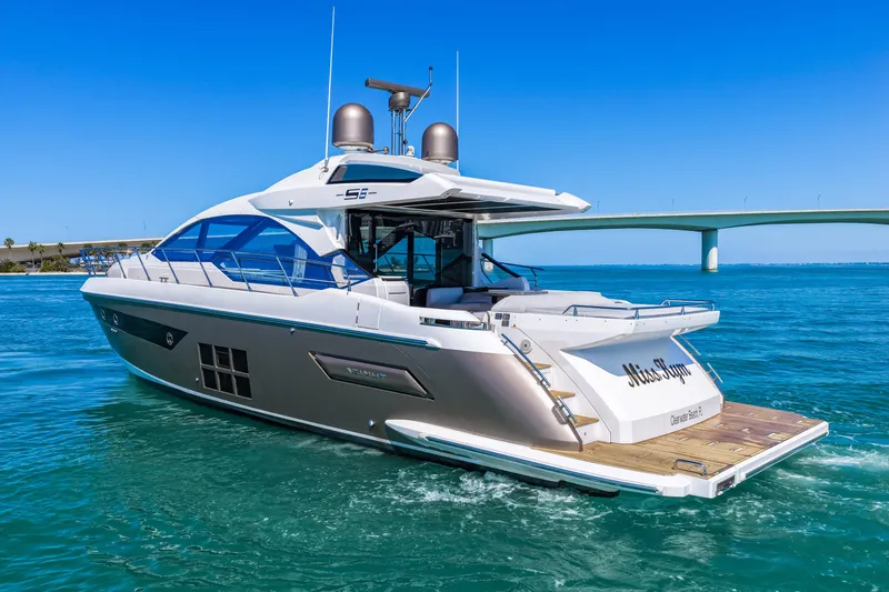 Slide: The Image of 2020 Azimut S6 yacht cruising on clear blue waters near a bridge. - 15