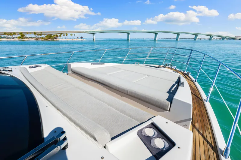 Slide: The Image of Luxurious 2020 Azimut S6 yacht deck with scenic ocean view and bridge in background. - 90