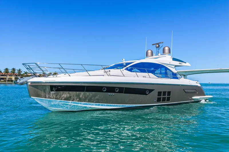 Slide: The Image of 2020 Azimut S6 yacht cruising on clear blue water under a sunny sky. - 2