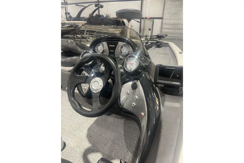 Slide: The Image of 2024 Tracker Pro Team 175 TXW boat dashboard with steering wheel and gauges. - 42