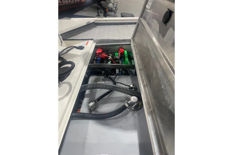 Slide: The Image of 2024 Tracker Pro Team 175 TXW boat interior showing wiring and battery compartment. - 43