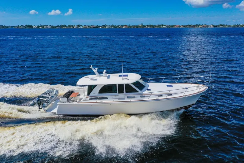 Slide: The Image of 2019 Sabre 45 Salon Express yacht cruising on open blue water. - 102