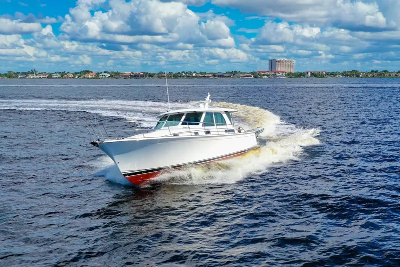 Slide: The Image of 2019 Sabre 45 Salon Express cruising on open water under a blue sky. - 104