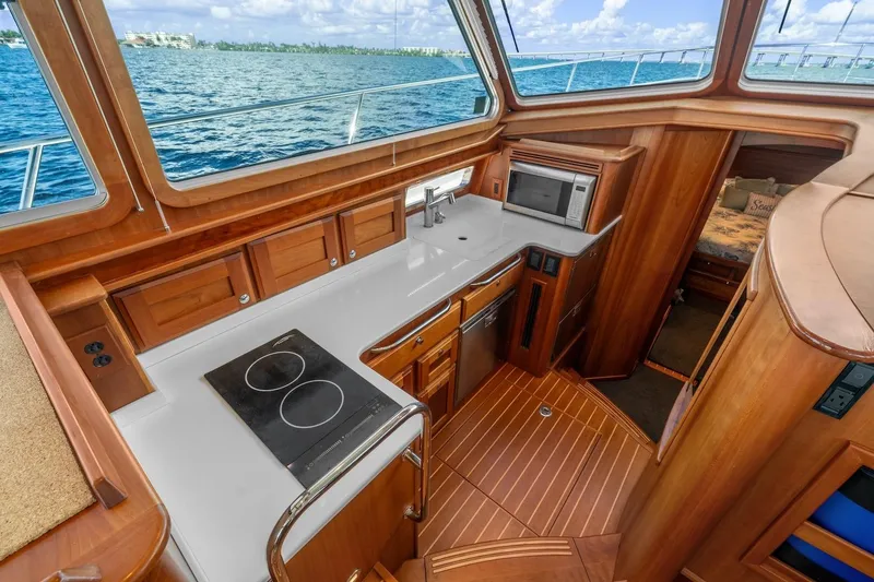 Slide: The Image of 2019 Sabre 45 Salon Express yacht interior with modern galley and ocean view. - 15