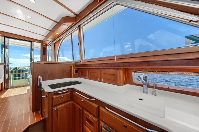 Slide: The Image of Luxurious interior of 2019 Sabre 45 Salon Express yacht with wooden cabinetry and ocean view. - 16