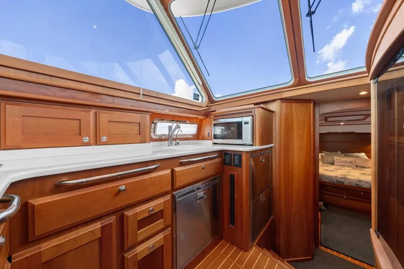 Slide: The Image of Interior of 2019 Sabre 45 Salon Express yacht with wooden cabinetry and modern amenities. - 20