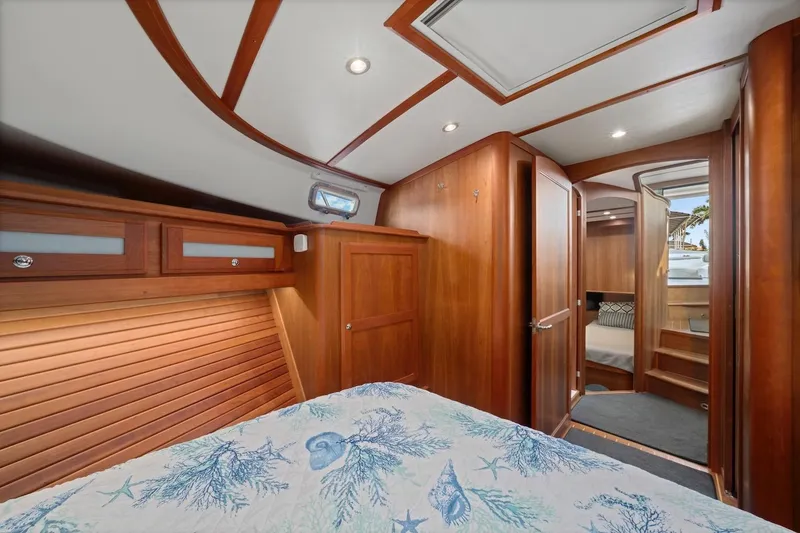 Slide: The Image of Luxurious interior of 2019 Sabre 45 Salon Express yacht with wood finish and cozy bedding. - 24