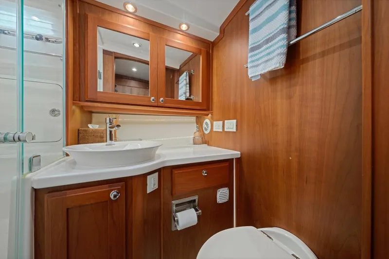 Slide: The Image of Luxurious 2019 Sabre 45 Salon Express bathroom with wood cabinetry and modern fixtures. - 29