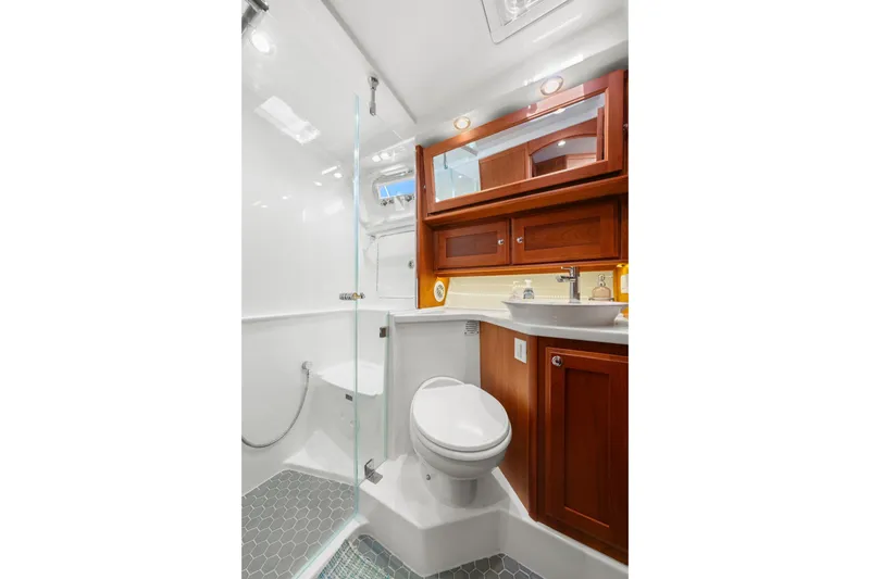 Slide: The Image of Luxurious bathroom in 2019 Sabre 45 Salon Express yacht with wood cabinetry and modern fixtures. - 30