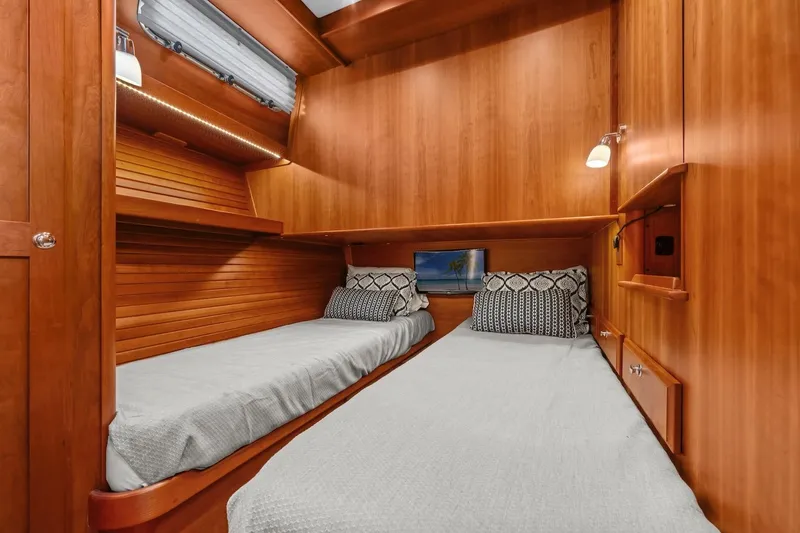 Slide: The Image of 2019 Sabre 45 Salon Express cabin with twin beds, wooden interior, and modern lighting. - 34