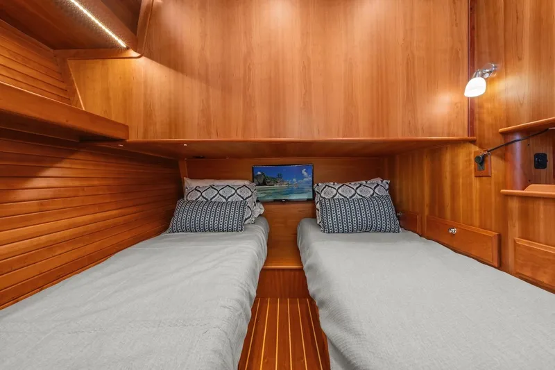 Slide: The Image of 2019 Sabre 45 Salon Express cabin with twin beds, wooden interior, and cozy lighting. - 35