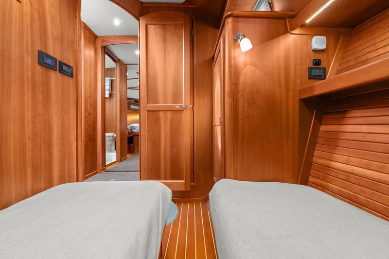 Slide: The Image of 2019 Sabre 45 Salon Express interior with wooden finish and twin beds. - 36