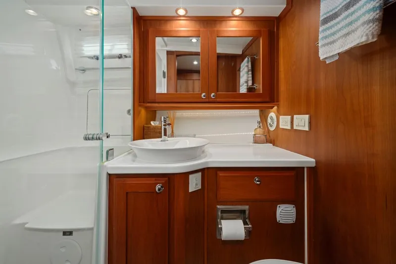 Slide: The Image of Luxurious bathroom in 2019 Sabre 45 Salon Express yacht with wood cabinetry and modern fixtures. - 40