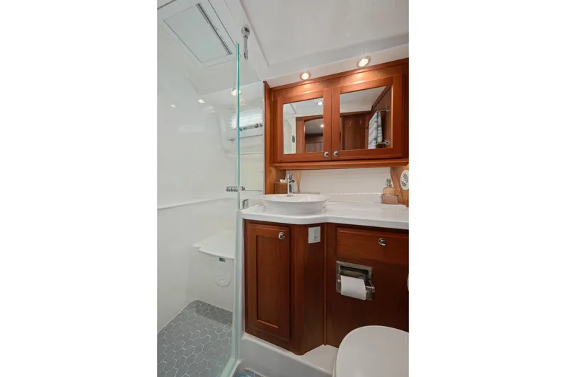 Slide: The Image of Luxurious bathroom in 2019 Sabre 45 Salon Express yacht with wood cabinetry and modern fixtures. - 47