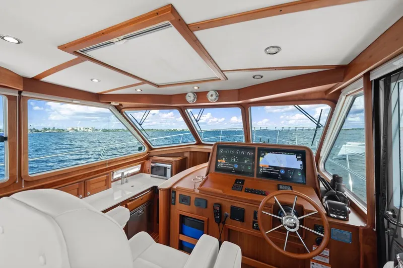 Slide: The Image of Interior view of 2019 Sabre 45 Salon Express yacht helm with ocean backdrop. - 49