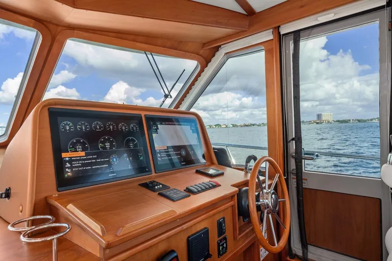 Slide: The Image of 2019 Sabre 45 Salon Express helm with digital displays and ocean view. - 50
