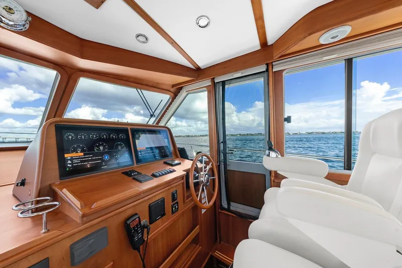 Slide: The Image of Interior view of 2019 Sabre 45 Salon Express yacht helm with ocean backdrop. - 51