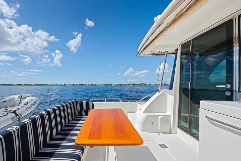 Slide: The Image of 2019 Sabre 45 Salon Express yacht with outdoor seating and ocean view. - 62