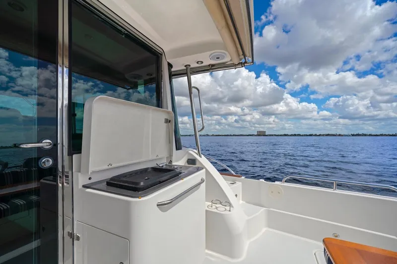 Slide: The Image of 2019 Sabre 45 Salon Express yacht deck with ocean view and grill station. - 66
