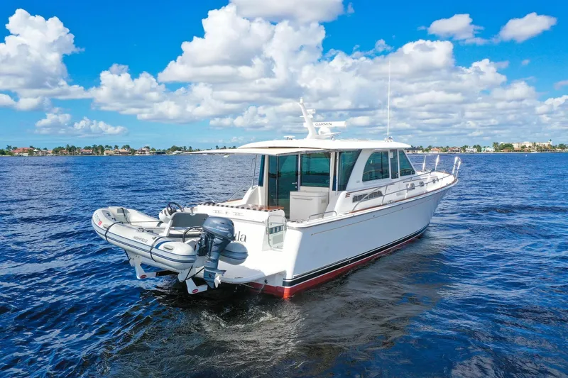 Slide: The Image of 2019 Sabre 45 Salon Express yacht on open water under a bright blue sky. - 68