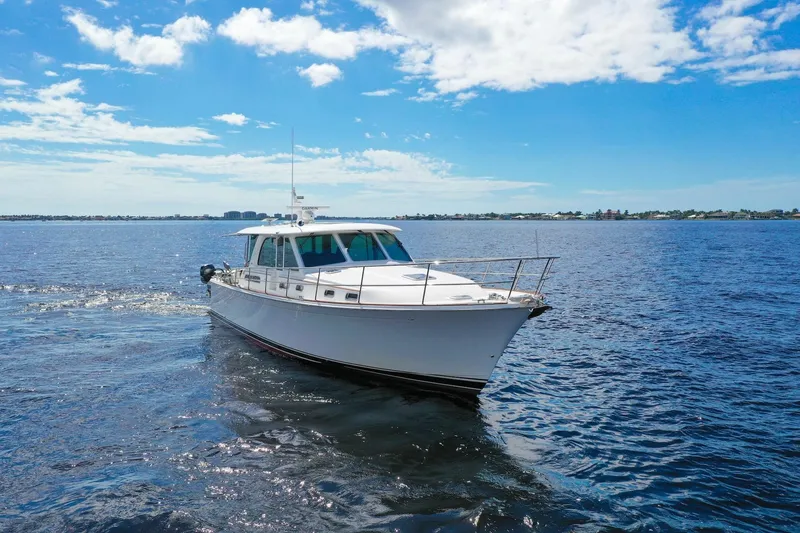 Slide: The Image of 2019 Sabre 45 Salon Express cruising on open water under a clear blue sky. - 71
