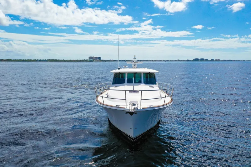Slide: The Image of 2019 Sabre 45 Salon Express yacht cruising on open water under a clear blue sky. - 72