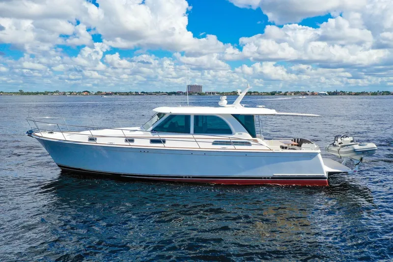 Slide: The Image of 2019 Sabre 45 Salon Express yacht cruising on open water under a blue sky. - 75