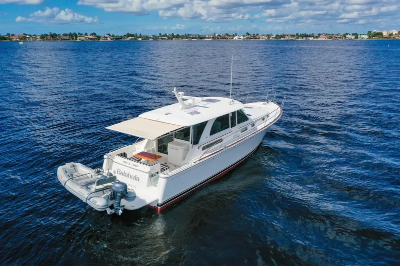 Slide: The Image of 2019 Sabre 45 Salon Express yacht cruising on open water under a partly cloudy sky. - 78