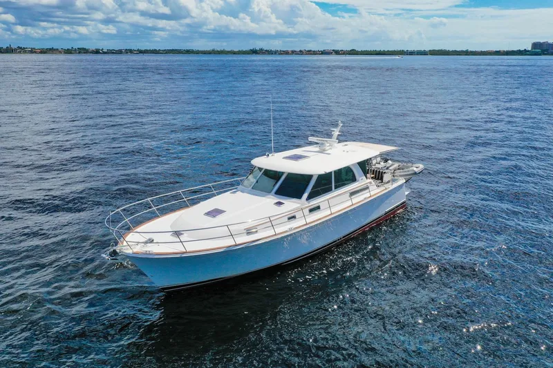 Slide: The Image of 2019 Sabre 45 Salon Express yacht cruising on open water under a clear sky. - 83