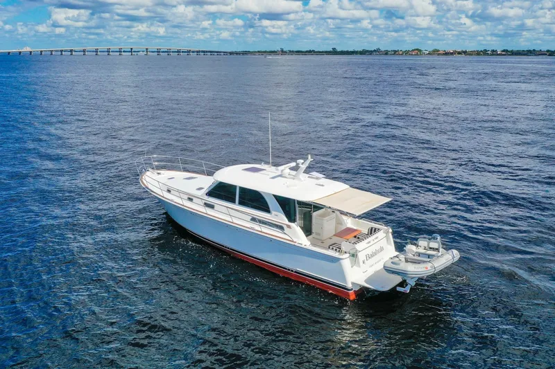 Slide: The Image of 2019 Sabre 45 Salon Express yacht cruising on open water under a cloudy sky. - 86