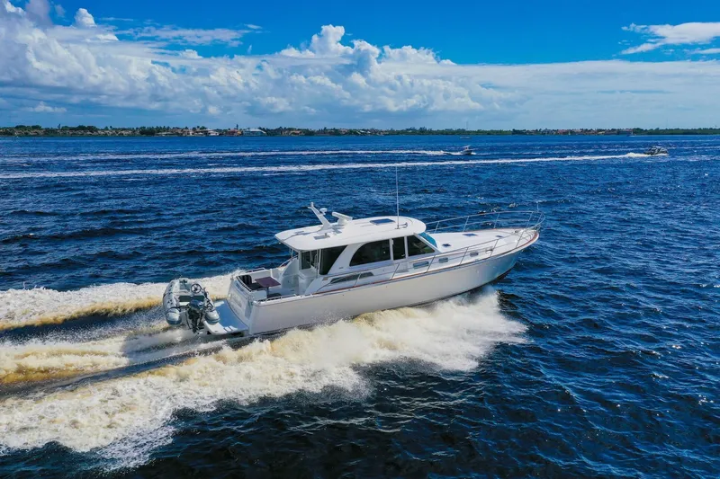 Slide: The Image of 2019 Sabre 45 Salon Express cruising on open water under a clear blue sky. - 87