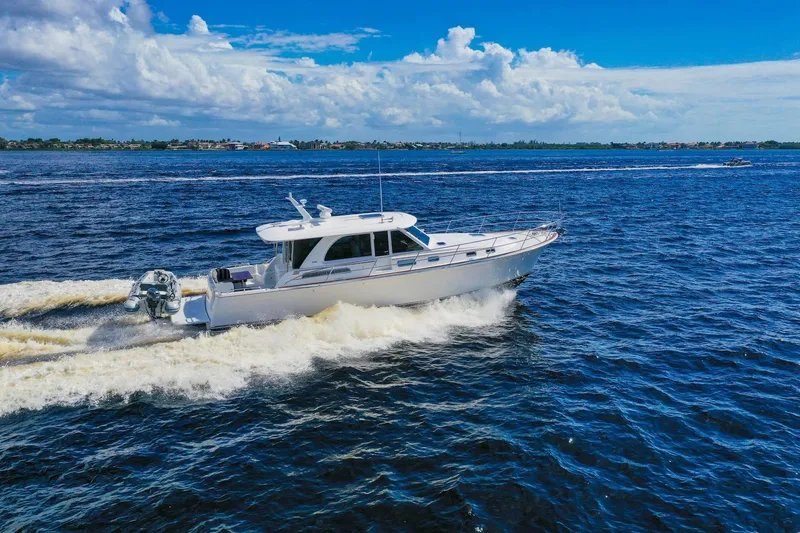 Slide: The Image of 2019 Sabre 45 Salon Express cruising on open water under a clear blue sky. - 88