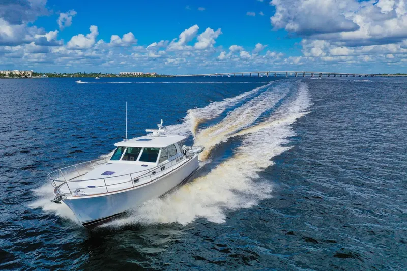 Slide: The Image of 2019 Sabre 45 Salon Express cruising on open water under a blue sky. - 91