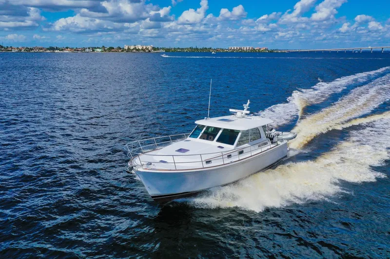 Slide: The Image of 2019 Sabre 45 Salon Express cruising on open water under a blue sky. - 93