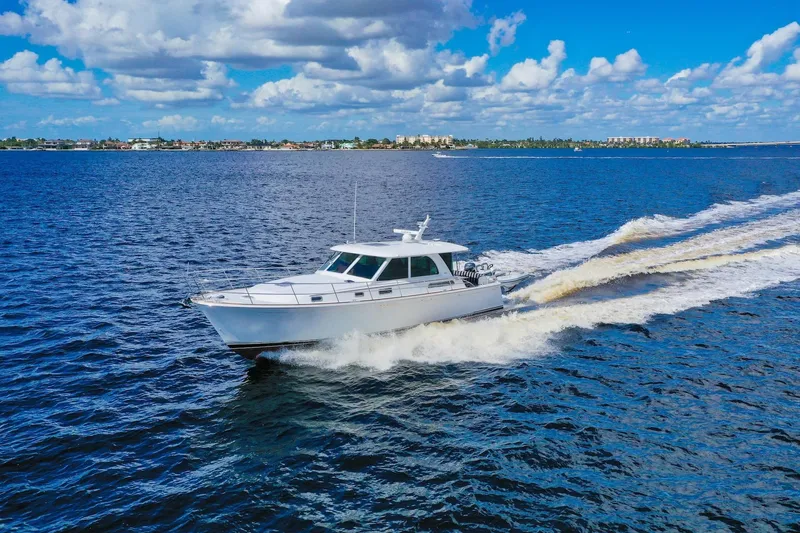 Slide: The Image of 2019 Sabre 45 Salon Express cruising on open water under a blue sky. - 94