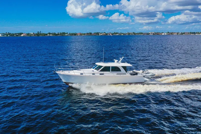 Slide: The Image of 2019 Sabre 45 Salon Express cruising on open water under a partly cloudy sky. - 96