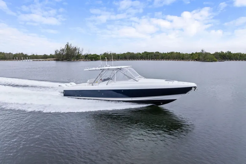 The Image of 2011 Intrepid 370 Cuddy cruising on calm waters under a partly cloudy sky. - 0