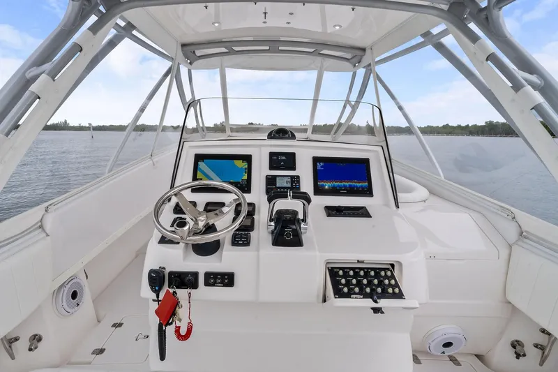 Slide: The Image of Cockpit of 2011 Intrepid 370 Cuddy boat with navigation screens and steering wheel. - 10