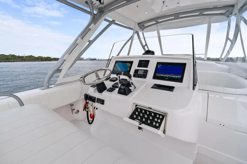 Slide: The Image of 2011 Intrepid 370 Cuddy boat helm with modern navigation equipment and spacious seating. - 11