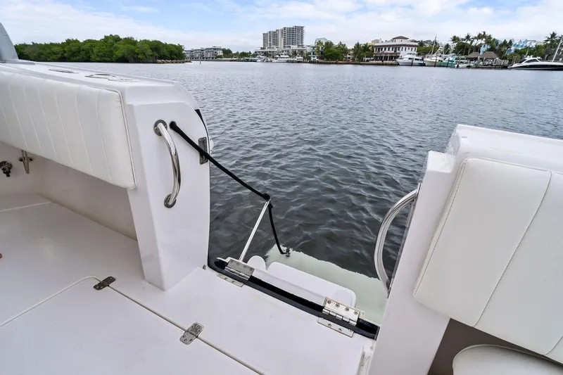 Slide: The Image of 2011 Intrepid 370 Cuddy boat with open deck view, docked near waterfront buildings. - 14